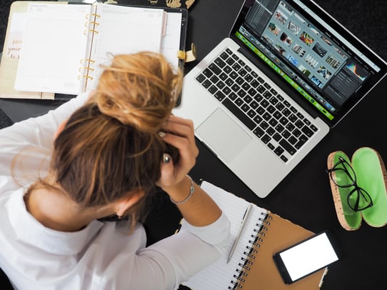 Stressed woman working on laptop