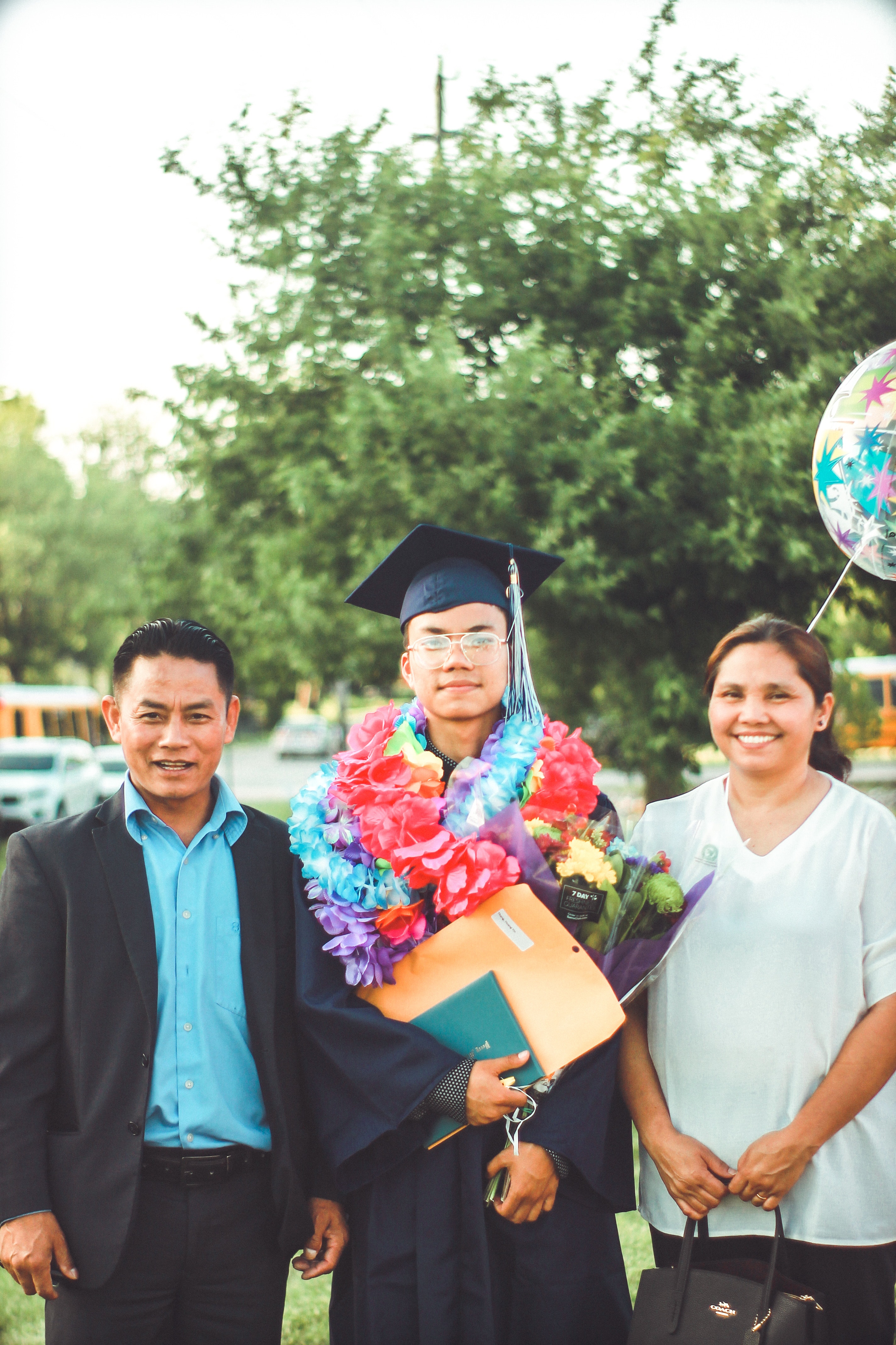 Parents and Son at college convocation ceremony 